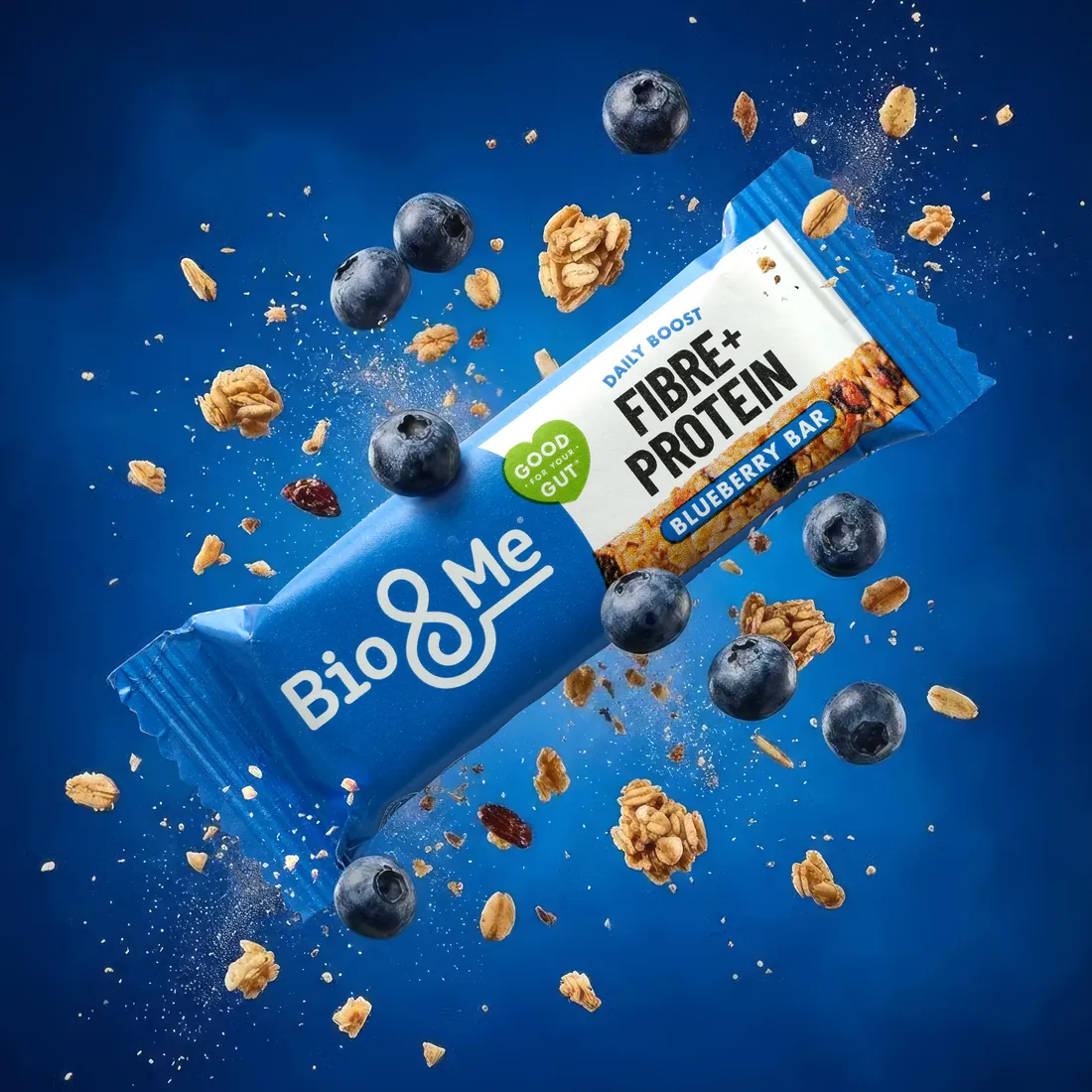Hero image of a protein bar with flying blueberries and oat flakes on a deep blue backdrop