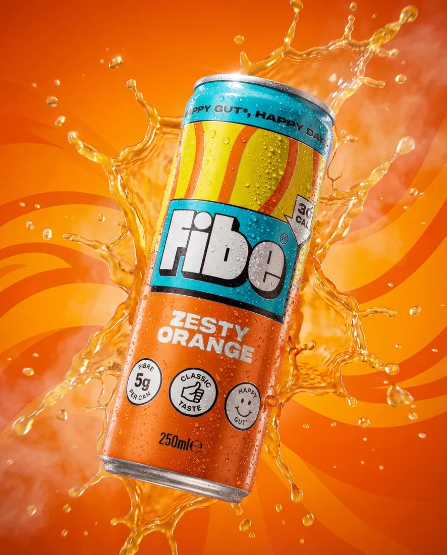 Hero image of a fibre drink can surrounded by a dramatic orange juice splash on an orange backdrop