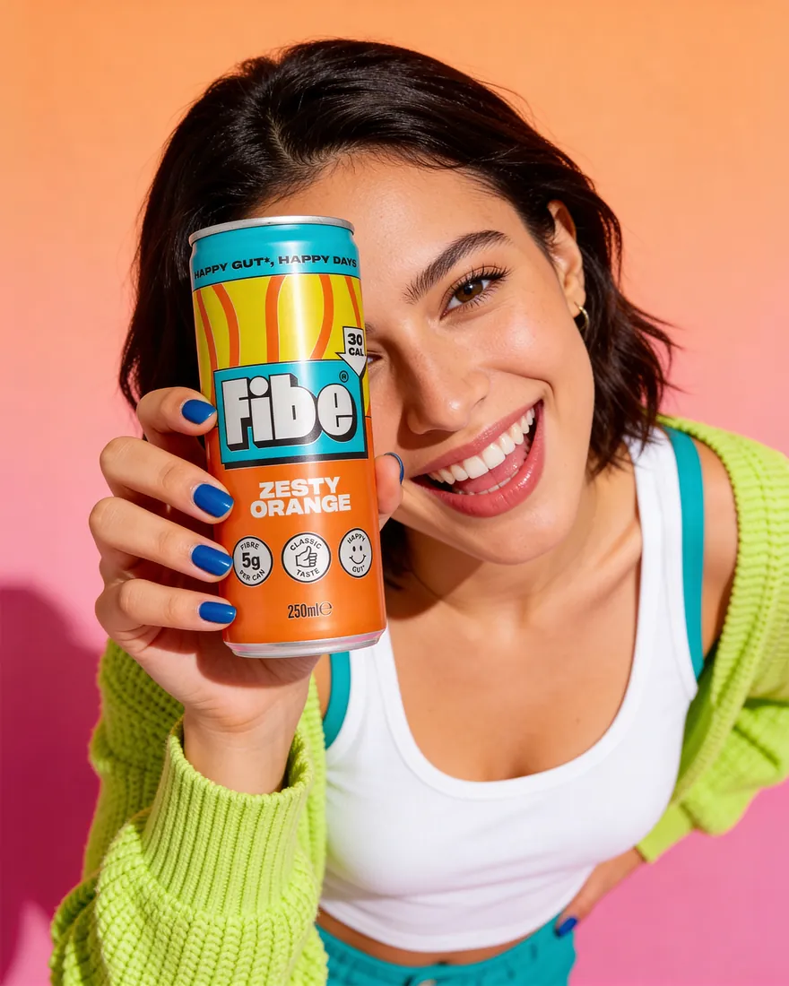 In-situ image of a smiling young woman holding a fibre drink can