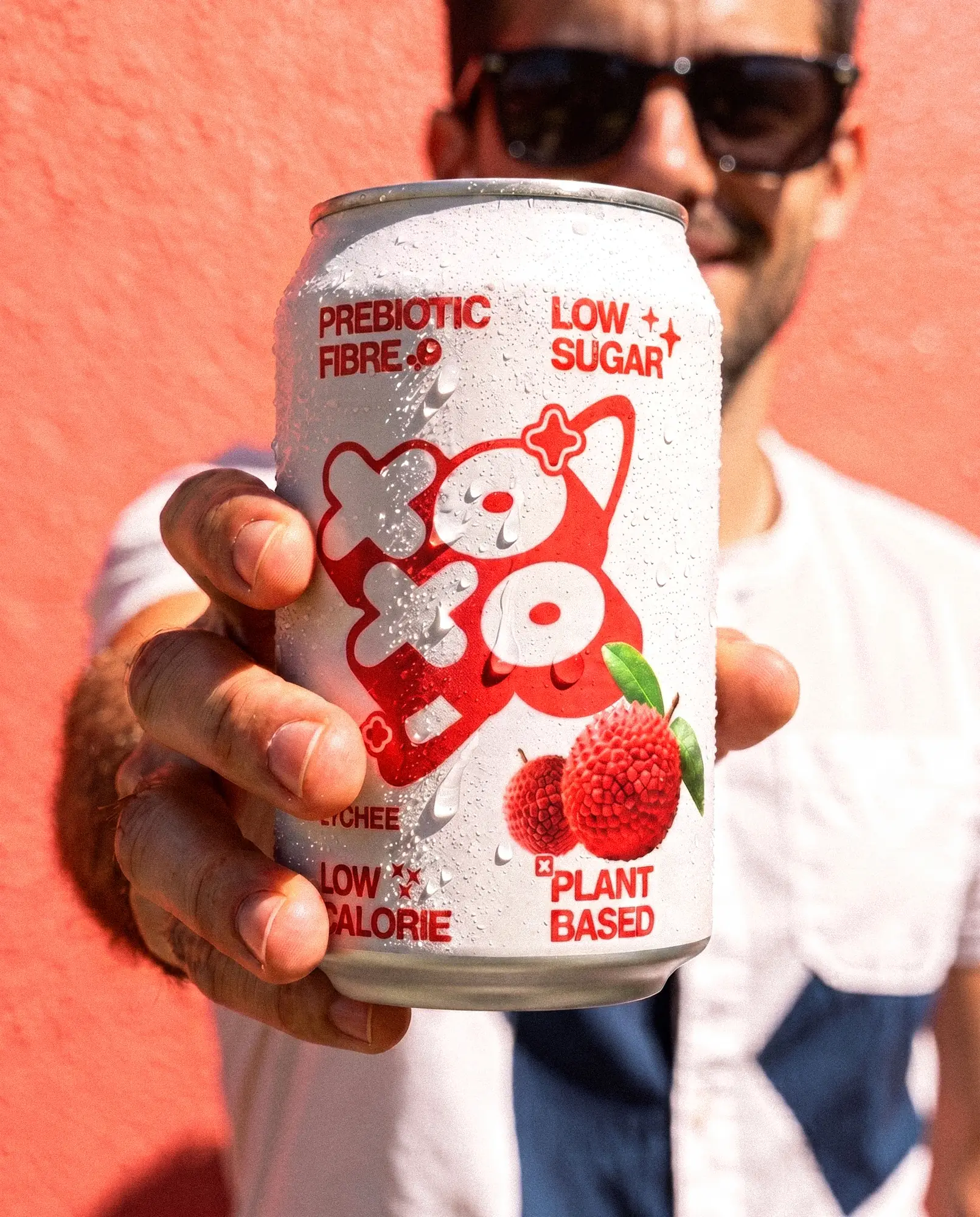 Close-up of a man in a white shirt with the same lychee can