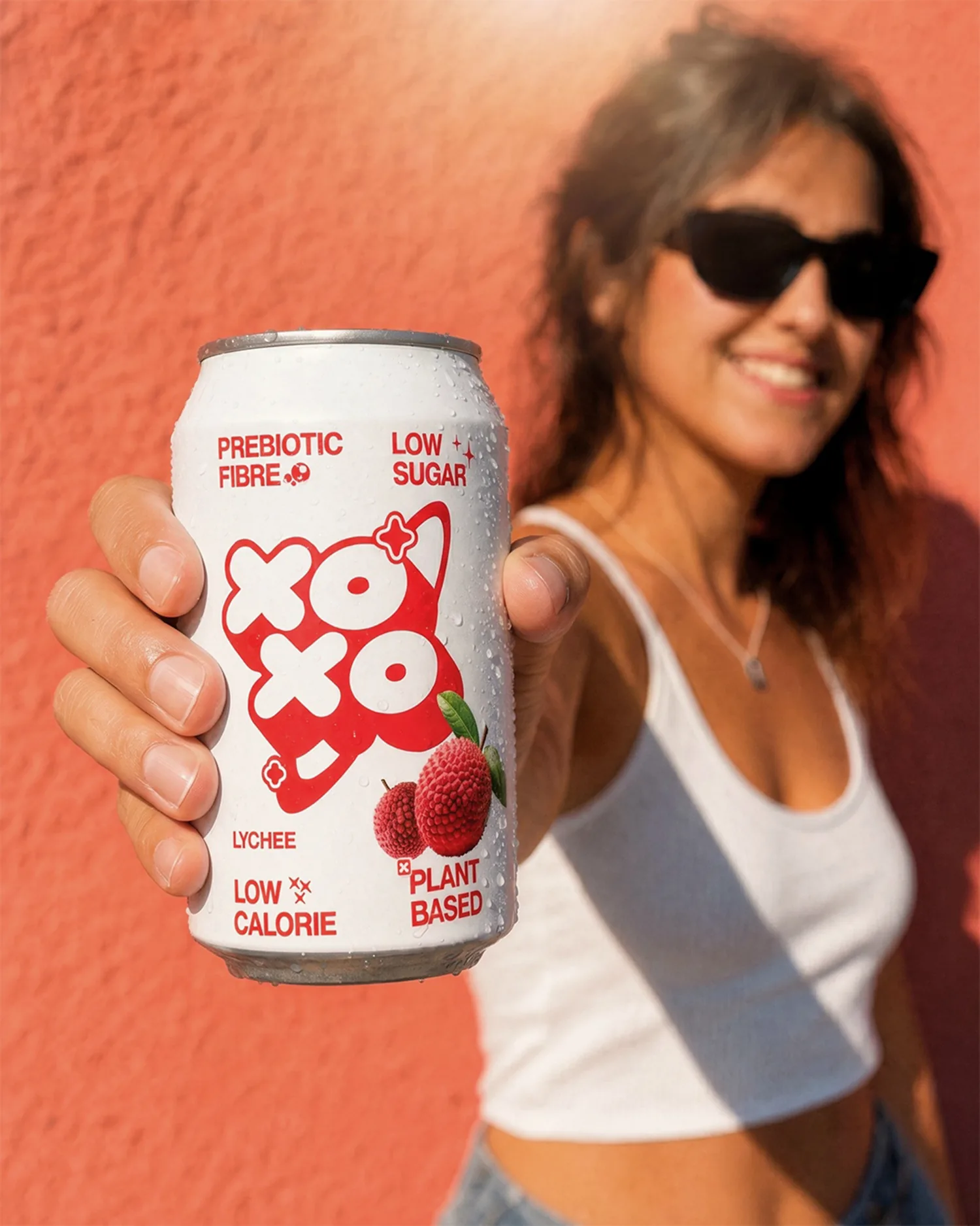 Smiling woman in sunglasses with the same lychee can