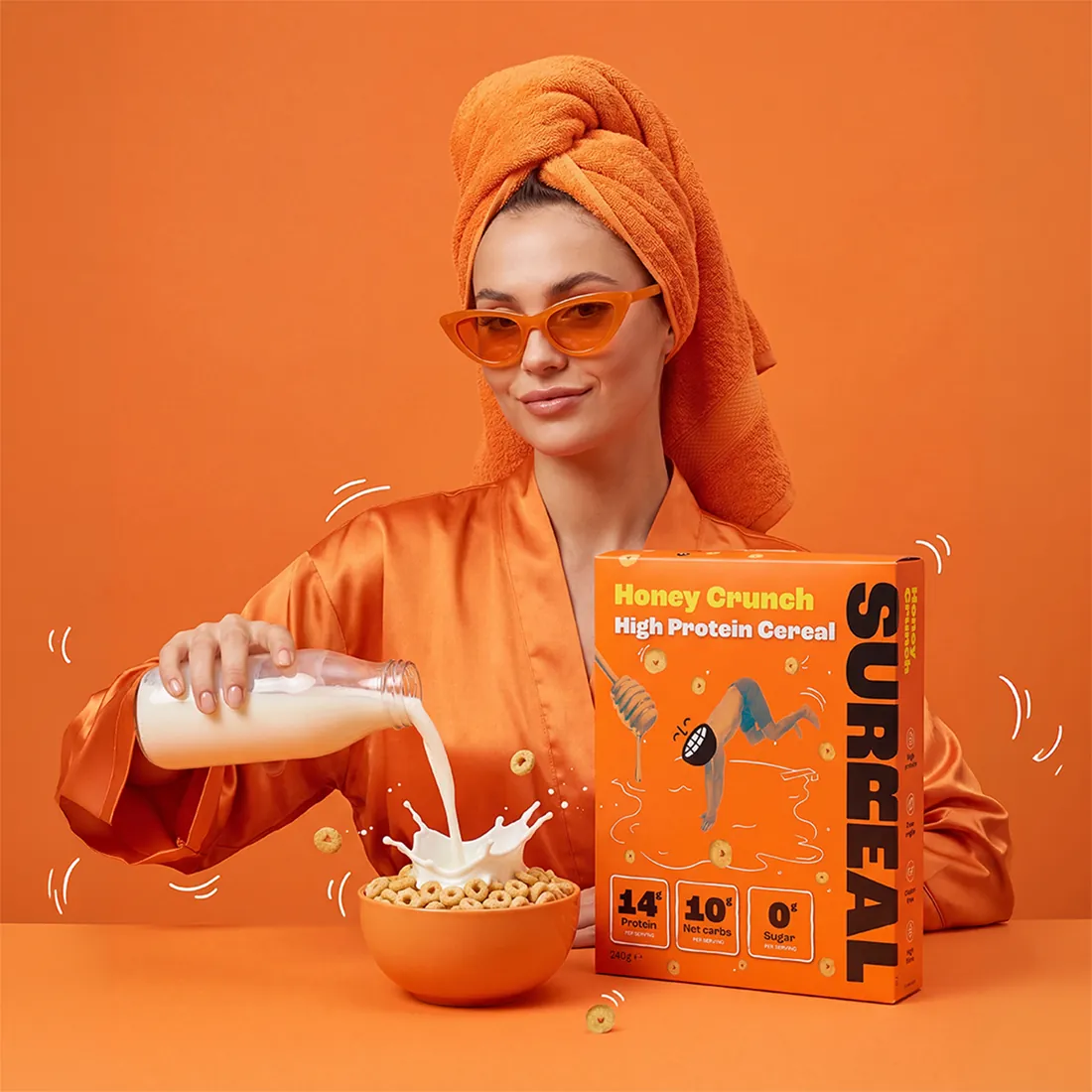 Editorial image of a model in orange sunglasses and towel pouring milk over a cereal bowl